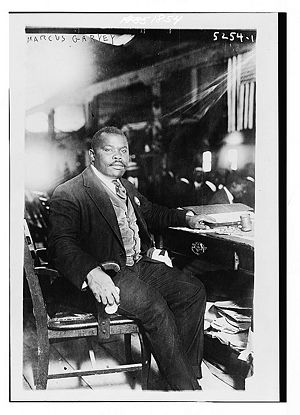 Marcus Garvey sitting at a desk, taken August 5, 1924.